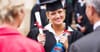 Female law graduate receives Windex to clean the glass ceiling