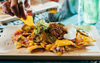 Group Sharing Pub Nachos Prepare To Judge The First Friend To Go Knuckles Deep In The Mince