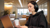 Party Girl Coworker Signals Bad Tuesday Comedown By Blocking Out World With Hoodie And Headphone Combo