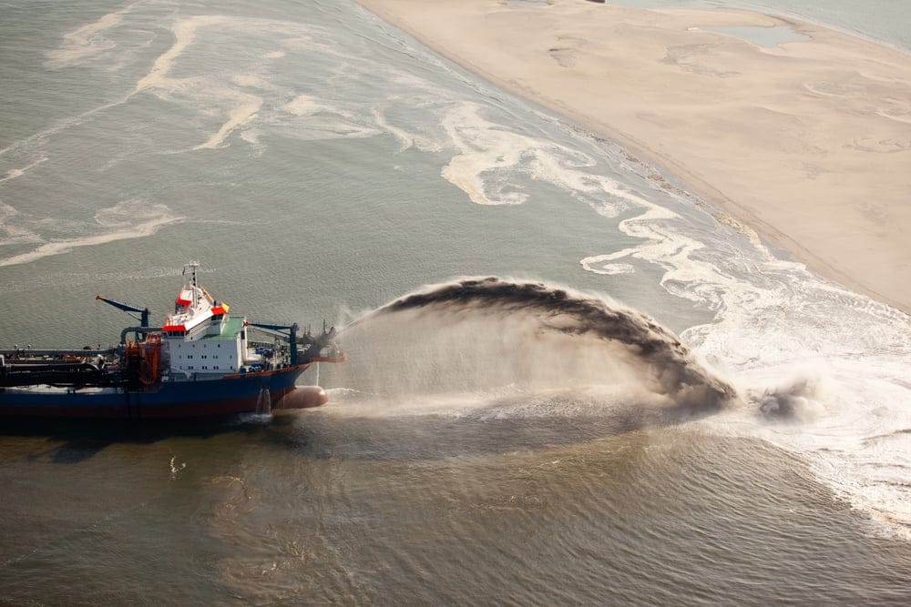 Coral cleaners in action near Mackay, QLD. They dump old dirty coral on to the beach, where it's sorted and removed by hermit crabs. SOURCE: LNP Brisbane.