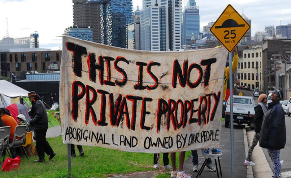 Protestors holding signs as the imminent eviction looms