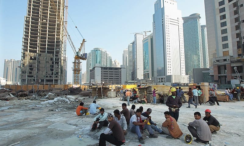 Scores of Nepalese slaves take a 5 minute break during 55 degree (Celsius) day