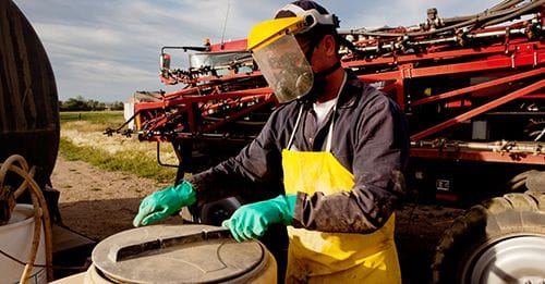 Farm workers are required to wear PPE when handling DHMO in some jurisdictions. PHOTO: Supplied